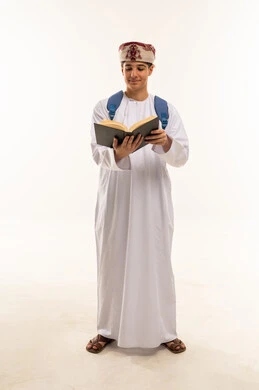 Omani Student in Traditional Dress Reading Book