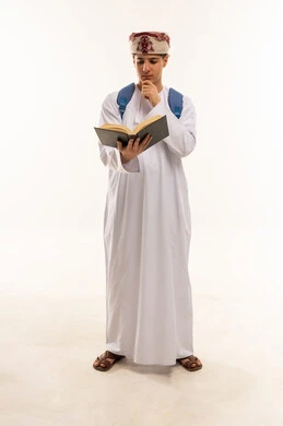 Omani Student in Traditional Dress Reading Book