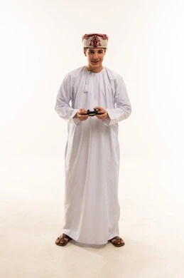 Omani Boy with Gaming Controller in Traditional Dress