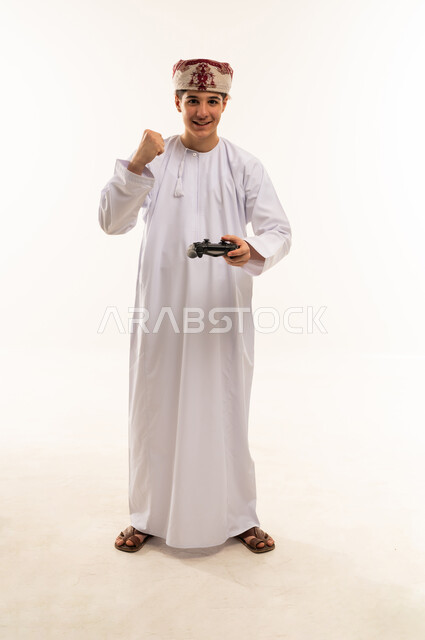 Omani Youth Celebrating Video Game Victory in Studio