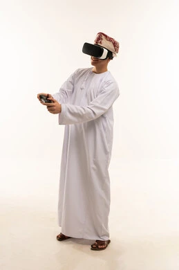 رجل عماني بالزي التقليدي يستخدم نظارة الواقع الافتراضي