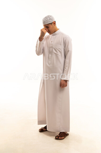 Stressed Arab Man in Traditional Thobe Studio Portrait