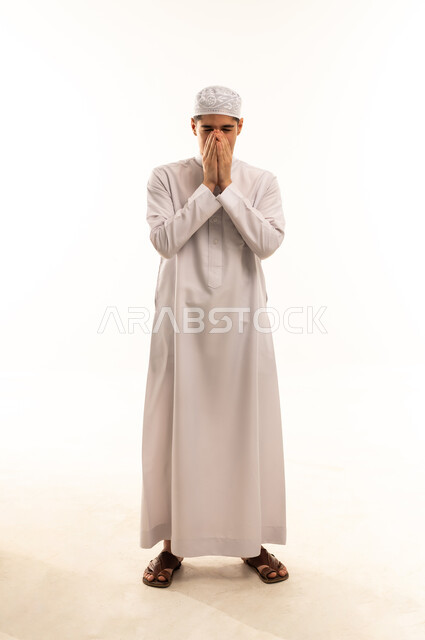 Saudi Man in Traditional Thobe Praying on White Background