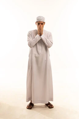 Saudi Man in Traditional Thobe Praying on White Background