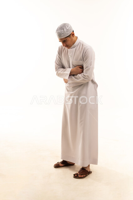 Saudi Man in Traditional Thobe Praying on White Background