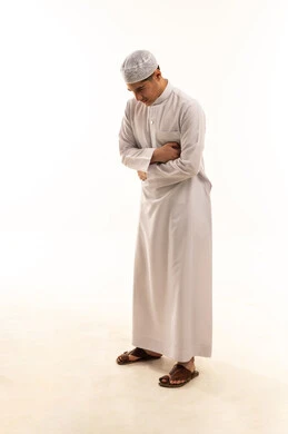 Saudi Man in Traditional Thobe Praying on White Background