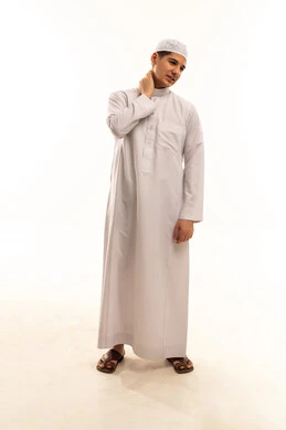 رجل سعودي بالثوب يعاني من ألم الرقبة بخلفية بيضاء