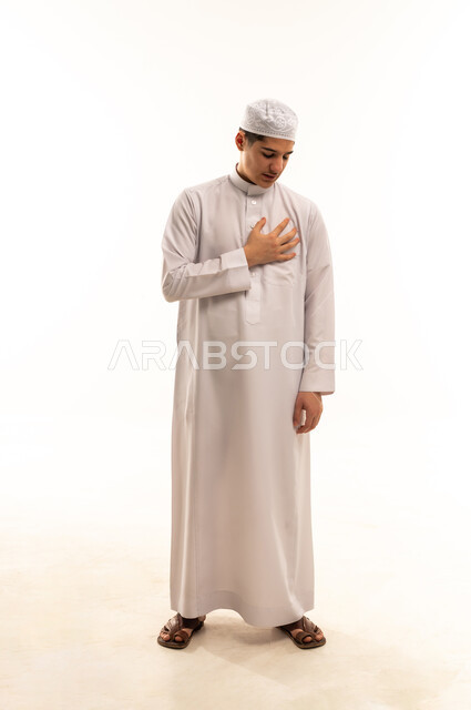 Saudi Boy in Traditional Thobe Respect Pose