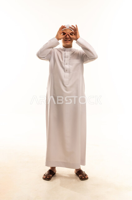 Saudi Boy in Thobe Making Binocular Hand Gesture
