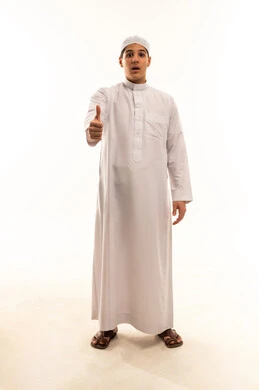 Saudi Boy in White Thobe Giving Thumbs Up