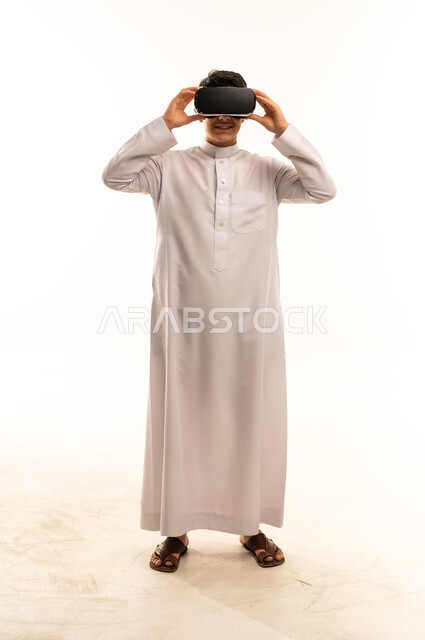 Saudi Man in White Thobe Using VR Headset