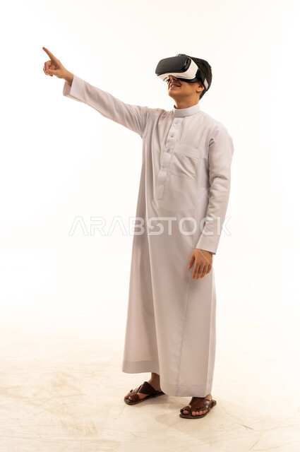 Saudi Man in Thobe Using VR Headset on White Background