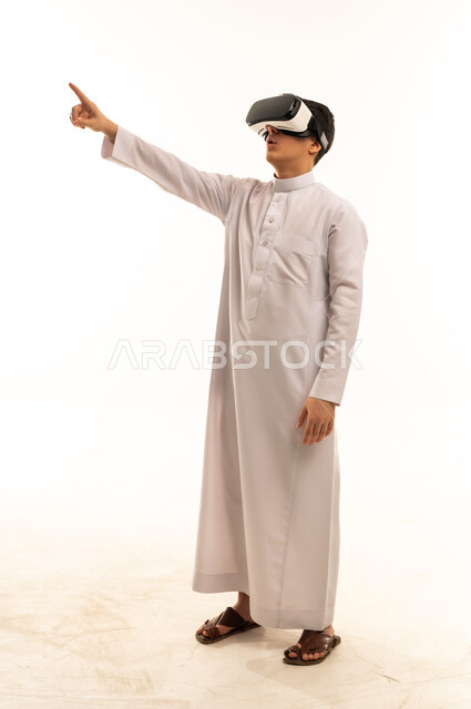 Saudi Man in Thobe Using VR Goggles on White Background