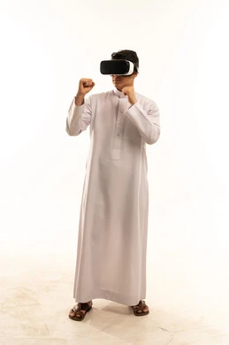 Saudi Man in Thobe Wearing VR Goggles Boxing Pose