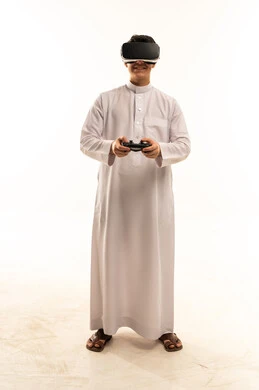 Saudi Man in Thobe Using VR Headset on White Background
