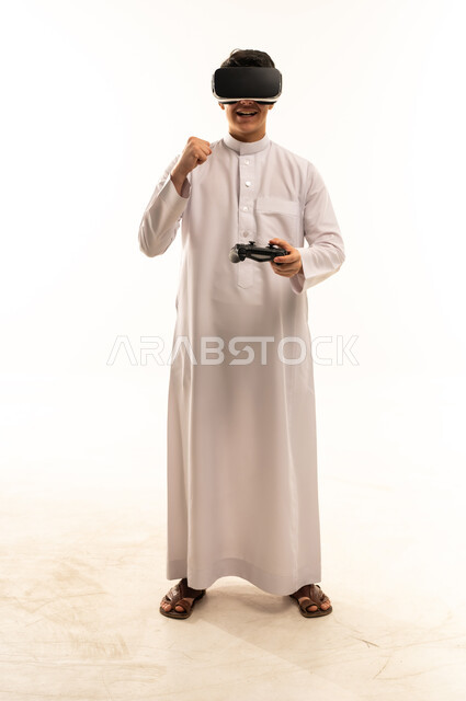 Saudi Man in Thobe Using VR Headset and Controller