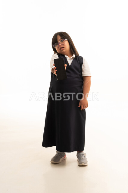 Saudi Girl with Down Syndrome Holding Smartphone
