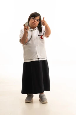 طفلة سعودية بمتلازمة داون في زي طبي