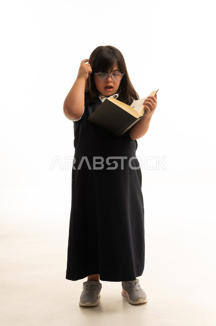Arab Girl with Down Syndrome Reading School Book