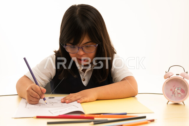 Girl with Down Syndrome Drawing in School Notebook