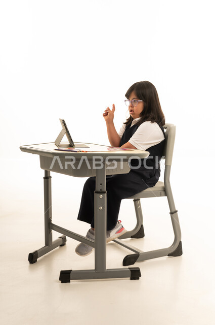 Arab Girl with Down Syndrome Studying with Tablet