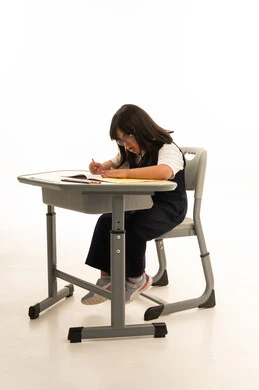 طفلة عربية من ذوي متلازمة داون تكتب على مقعد دراسي