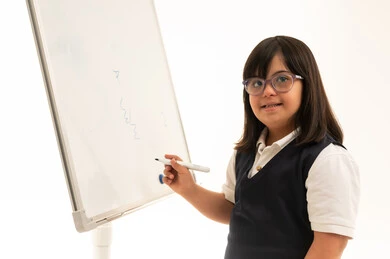 Arab Girl with Down Syndrome at School Whiteboard