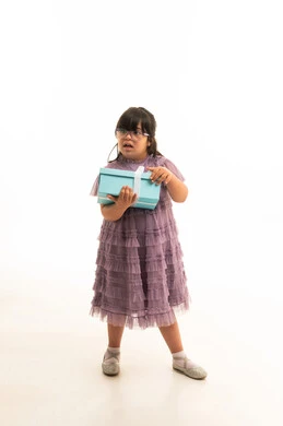 Saudi Girl with Down Syndrome Holding Gift Box in Studio