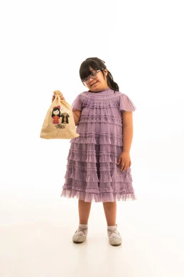 Saudi Girl with Down Syndrome Holding Ramadan Gift Bag
