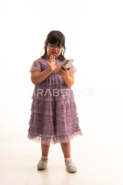Arab Girl with Down Syndrome Using Smartphone in Studio