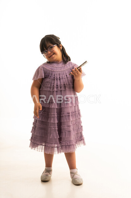 Arab Girl with Down Syndrome Holding Smartphone