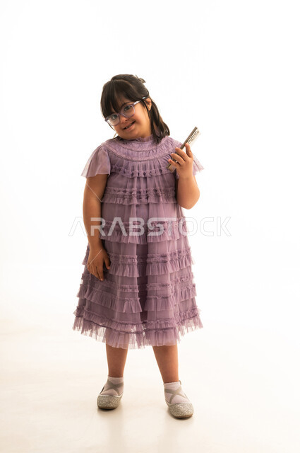 Saudi Girl with Down Syndrome Holding Smartphone