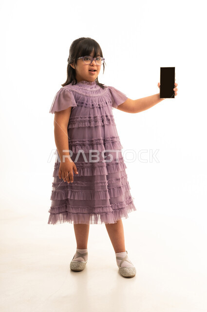 Saudi Girl with Down Syndrome Holding Smartphone