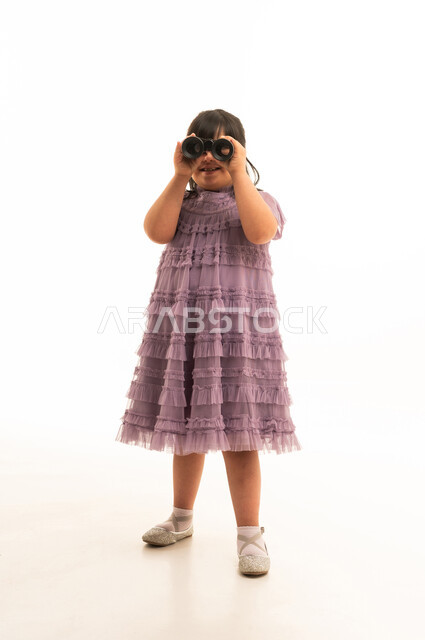 Arab Girl with Down Syndrome Holding Binoculars