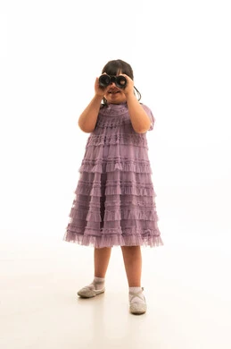 Arab Girl with Down Syndrome Holding Binoculars