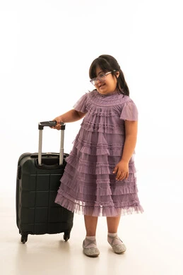 طفلة سعودية من ذوي متلازمة داون مع حقيبة سفر