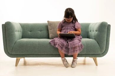 Middle Eastern Girl with Down Syndrome Using Tablet