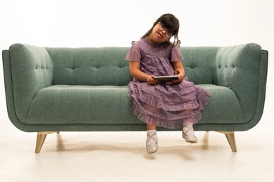 طفلة من ذوي الاحتياجات الخاصة تستخدم جهاز لوحي