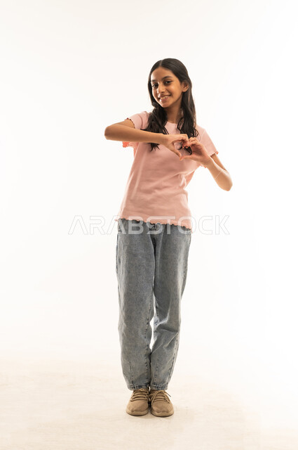Saudi Girl Making Heart Shape Hand Gesture White Background