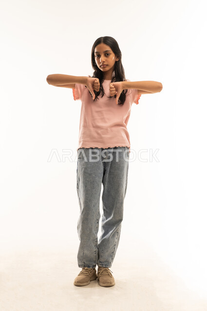 Omani Girl Showing Thumbs Down on White Background