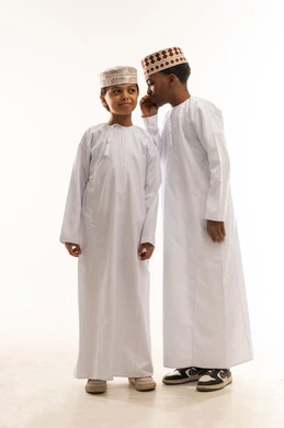 Omani Boys in Traditional Dress Whispering in Studio