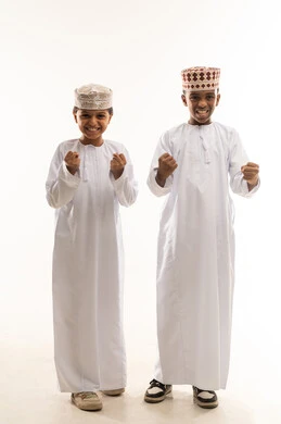Omani Boys in Traditional Dress Celebrating Success