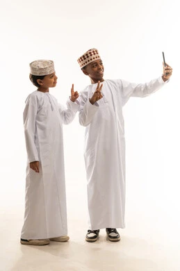 Omani Boys in Traditional Dress Taking Selfie White Background