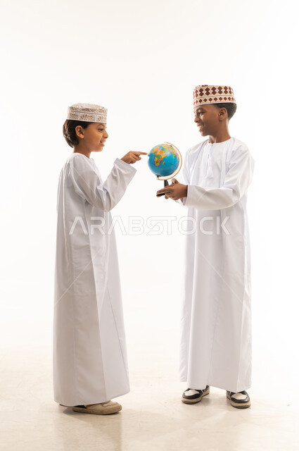 Omani Boys in Traditional Dress with Globe