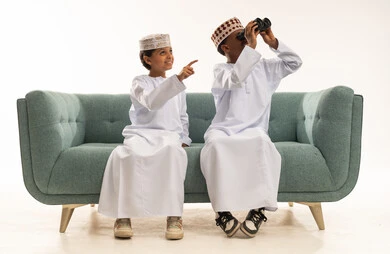 Omani Boys with Binoculars on Sofa Studio Shot