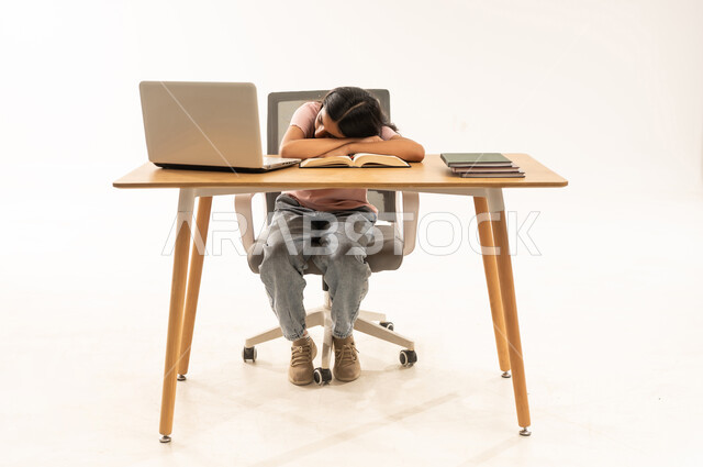 Tired Saudi Girl Sleeping on Desk with Laptop