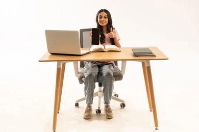 Arab Girl Student at Desk Holding Smartphone