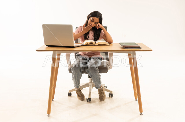 Tired Arab Girl Yawning at Desk with Laptop