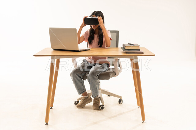 Arab Woman Wearing VR Headset at Office Desk