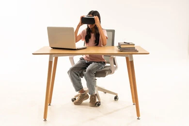 Arab Woman Wearing VR Headset at Office Desk